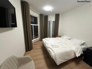 a bedroom with a white bed and a chair at Voyagers Amsterdam in Amsterdam +27 photos