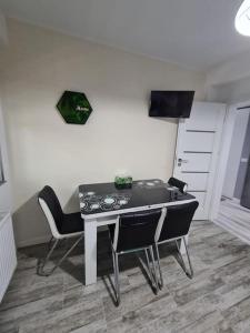 a dining room with a table and chairs in a room at Confort Residence in Craiova