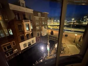 a view from a window of a city at night at Voyagers Amsterdam in Amsterdam