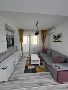 a living room with a couch and a table at Confort Residence in Craiova