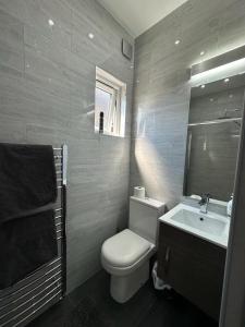 y baño con aseo blanco y lavamanos. en Second Av flat 4 Hendon London en Hendon