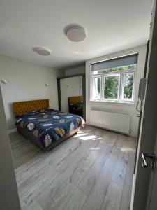 a bedroom with a bed and a large window at Second Av flat 4 Hendon London in Hendon