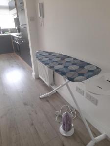 a table in a kitchen with a hat on the floor at Second Av flat 4 Hendon London in Hendon