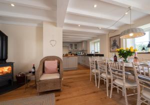 a kitchen and dining room with a table and chairs at Barton Farm in West Down
