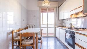 a kitchen with a table and chairs and a counter at Casa Pucci - Affitti Brevi Italia in Modena +31 photos