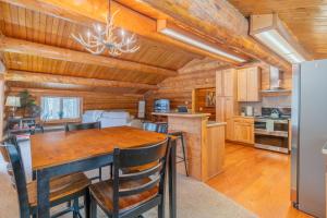 a dining room and kitchen with a wooden ceiling at Tucked Away Timbers in Fairbanks