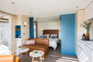 a hotel room with a bed and a couch at PetraLegna in Porto-Vecchio