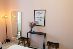 a room with a mirror and a vase of flowers at Naples Pizza Hostel in Naples +54 photos