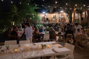 a group of people sitting at tables at a party at Gallina Varja in Sotta