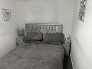 a bed with two pillows on it in a bedroom at Beautiful 1-Bed House in Bradford in Bradford