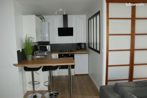 a small kitchen with a counter and a stove top oven at Les Jardins du Port Vannes in Vannes
