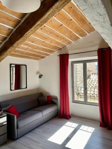 a living room with a couch and a window at LA CALADE in Trigance