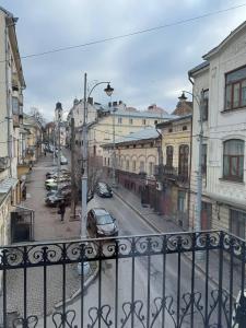 a view of a city street from a balcony at Emerald Apartament in Chernivtsi