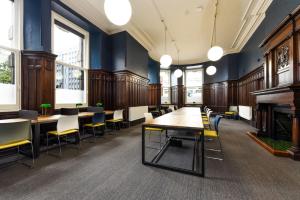 a large room with tables and chairs and windows at For Students Only Premium Studios and Private Ensuite Rooms at John Bell House in Belfast in Belfast
