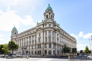 a large white building with a tower at For Students Only Premium Studios and Private Ensuite Rooms at John Bell House in Belfast in Belfast