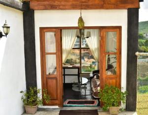 a front door of a house with a table at Shinycot in Nuwara Eliya
