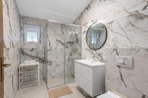 a bathroom with a shower and a toilet and a sink at Apartment ANTONIJA in Rogoznica +101 photos