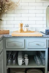 a kitchen island with a counter with dishes on it at Casa Idalia Boutique Hotel in Comporta
