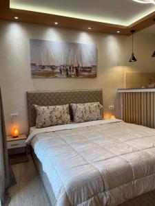 a bedroom with a large bed and a painting on the wall at ANDREA in Mali Mokri Lug