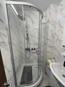 a white bathroom with a shower and a sink at ANDREA in Mali Mokri Lug +11 photos