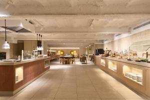 a large kitchen with a dining area in a restaurant at Catalonia Barcelona 505 in Barcelona