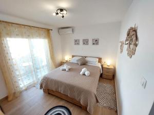a bedroom with a bed with two towels on it at Afandou Square Apartment in Afantou