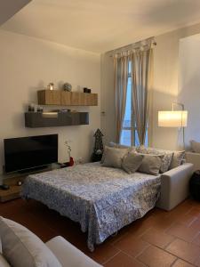 a bedroom with a bed and a flat screen tv at Garibaldi Roof Garden in Rome