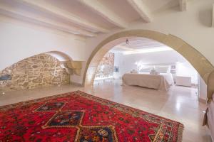 een slaapkamer met een bed en een rood tapijt bij Casa Scina' in Siracusa