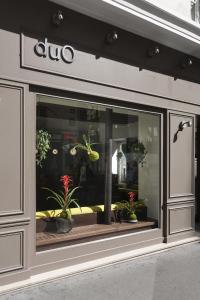 a store window with potted plants in it at Hôtel Duo in Paris