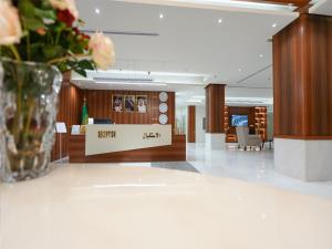 a lobby with a vase of flowers on a table at شقق همس بارك للشقق المخدومة in Jeddah