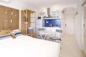 a bedroom with a bed and a small kitchen at Bambu Beach Studio by BHomesCostaBrava in Platja d'Aro