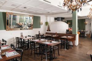 a dining room with wooden tables and chairs at Boutique Hotel Weisses Kreuz - Adult only Hotel in Lucerne