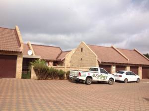 two cars parked in front of a house at Cozy 2BR 2BR Townhouse Netflix Private Parking Great Location in Bloemfontein