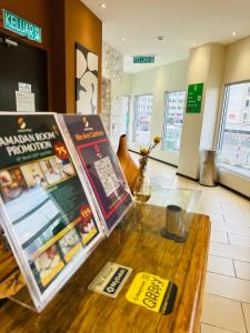 a table in a store with signs on it at Swing & Pillows - Apple Hotel Shah Alam in Shah Alam