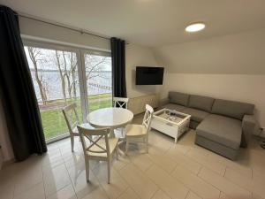 a living room with a couch and a table at Ferienappartement mit Schleiblick 20 in Karschau