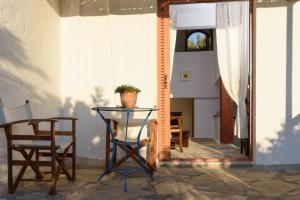 a table and a chair and a mirror at Elounda Island Villas in Elounda