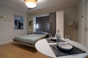 a bedroom with a bed and a table with wine glasses at Itinera Home Residence in Montalto Uffugo