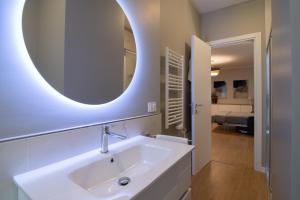 a bathroom with a sink and a mirror on the wall at Itinera Home Residence in Montalto Uffugo