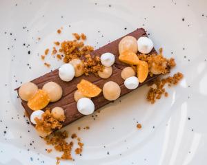 a piece of chocolate dessert with marshmallows and fruit on a plate at Sines Sea View Business & Leisure Hotel in Sines