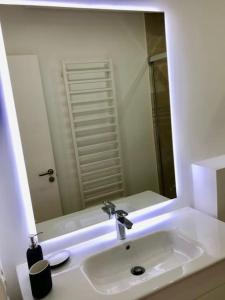 a bathroom with a sink and a large mirror at State of the Art Apartment in Magaluf