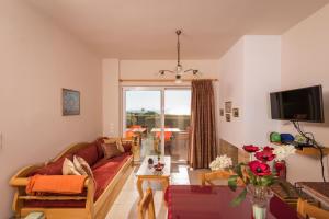 a living room with a couch and a table at Cretan View Apartments with sea view in Stavros