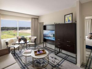 a living room with a couch and a tv at The William Inglis Mgallery in Warwick Farm