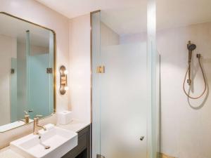 a bathroom with a sink and a shower at The William Inglis Mgallery in Warwick Farm