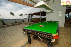 a pool table sitting on top of a patio at Saikiran Hotel in Mapusa