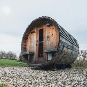 a wooden boat sitting on top of a pile of rocks at Hunsrück Valley View Apartment with Cedar SAUNA in Bruschied