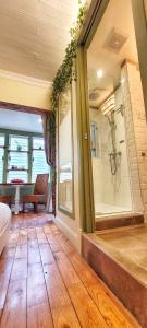 a large bathroom with a shower and a bench in a room at Le Ricochet Urbain in Quebec City