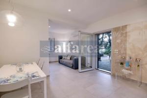 a bathroom with a sink and a couch in a room at Il Poggettino, esclusiva villetta a picco sul mare! by Alfareal in Castiglione della Pescaia +19 photos
