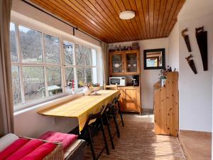 a kitchen with a long wooden table and some chairs at ALCHYMISTA MINING HOUSE in Špania Dolina