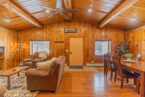 a living room with wood paneling and a ceiling at Northern Dream Estates in Fairbanks