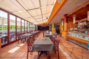 a row of tables and chairs in a restaurant at Camping La Masia - Maeva Vacansoleil in Blanes